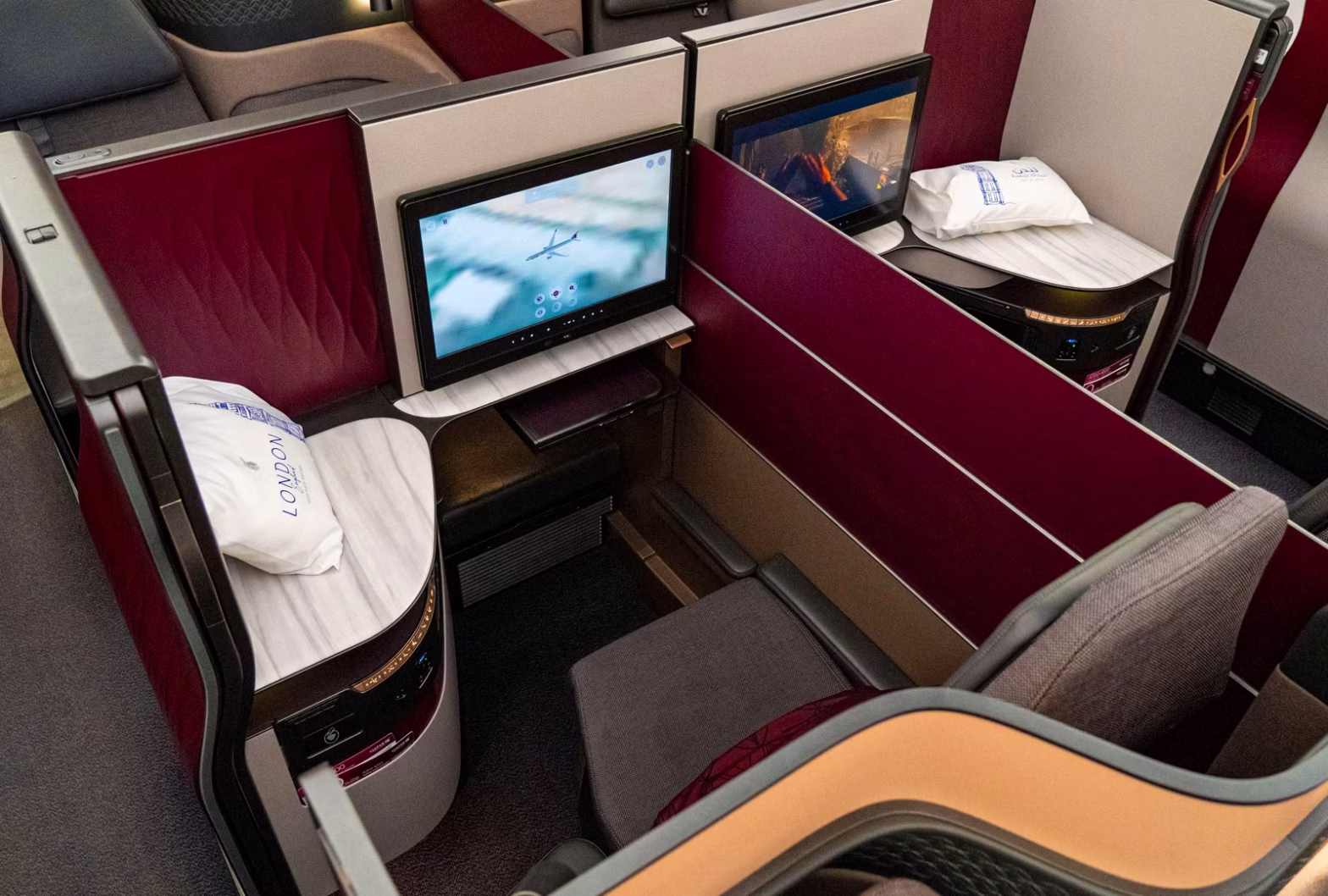 Qatar Airways Qsuite business class cabin with enclosed suites and sliding doors